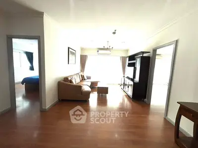 Spacious living room with wooden flooring and elegant furniture