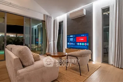 Luxurious modern living room with stylish furniture and large TV, perfect for entertainment and relaxation.