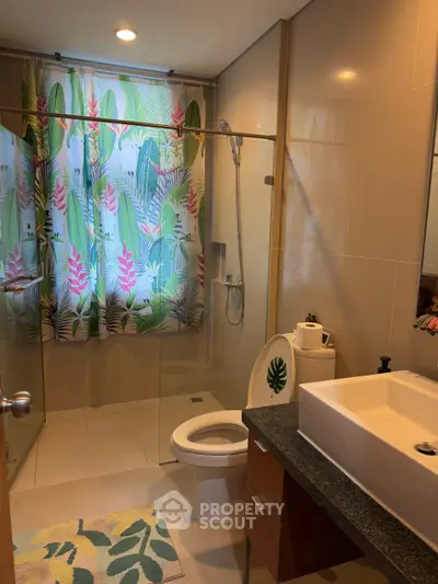 Charming bathroom with tropical shower curtain and modern fixtures