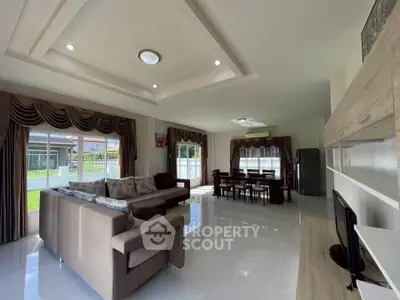 Spacious modern living room with elegant dining area and large windows for natural light.