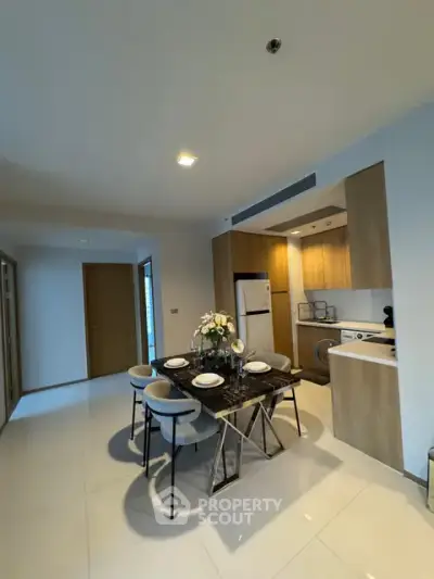 Modern kitchen with dining area featuring sleek design and contemporary furniture.