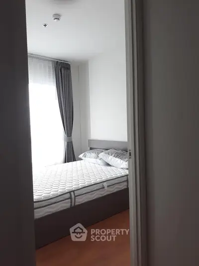 Cozy bedroom with modern decor and ample natural light