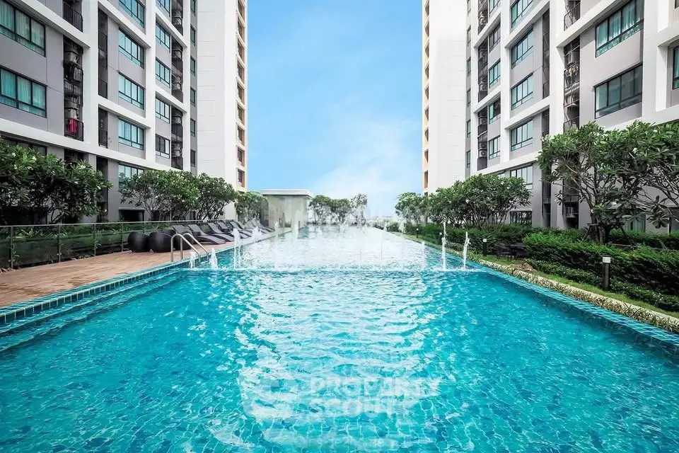 Luxurious condominium with a stunning outdoor pool and lush greenery, perfect for relaxation and leisure.