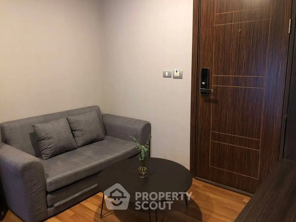 Cozy living room with modern sofa and sleek wooden door