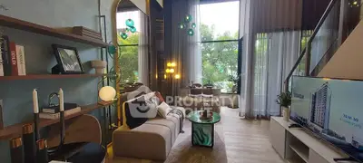 Luxurious living room with high ceilings, modern decor, and large windows offering a serene garden view.