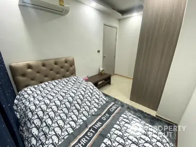 Cozy bedroom with modern decor and air conditioning, featuring stylish bed and sleek flooring.