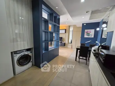 Modern open-plan kitchen and dining area with sleek appliances and stylish decor