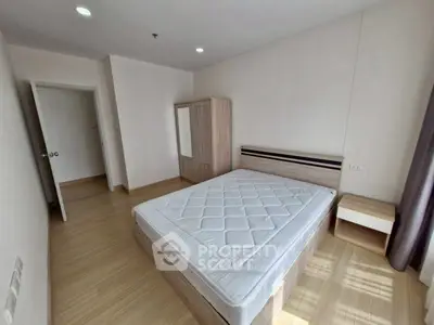 Spacious bedroom with natural light and modern furnishings in a stylish apartment.