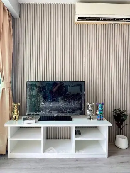 Modern living room with stylish TV stand and air conditioning, featuring contemporary decor and sleek design.
