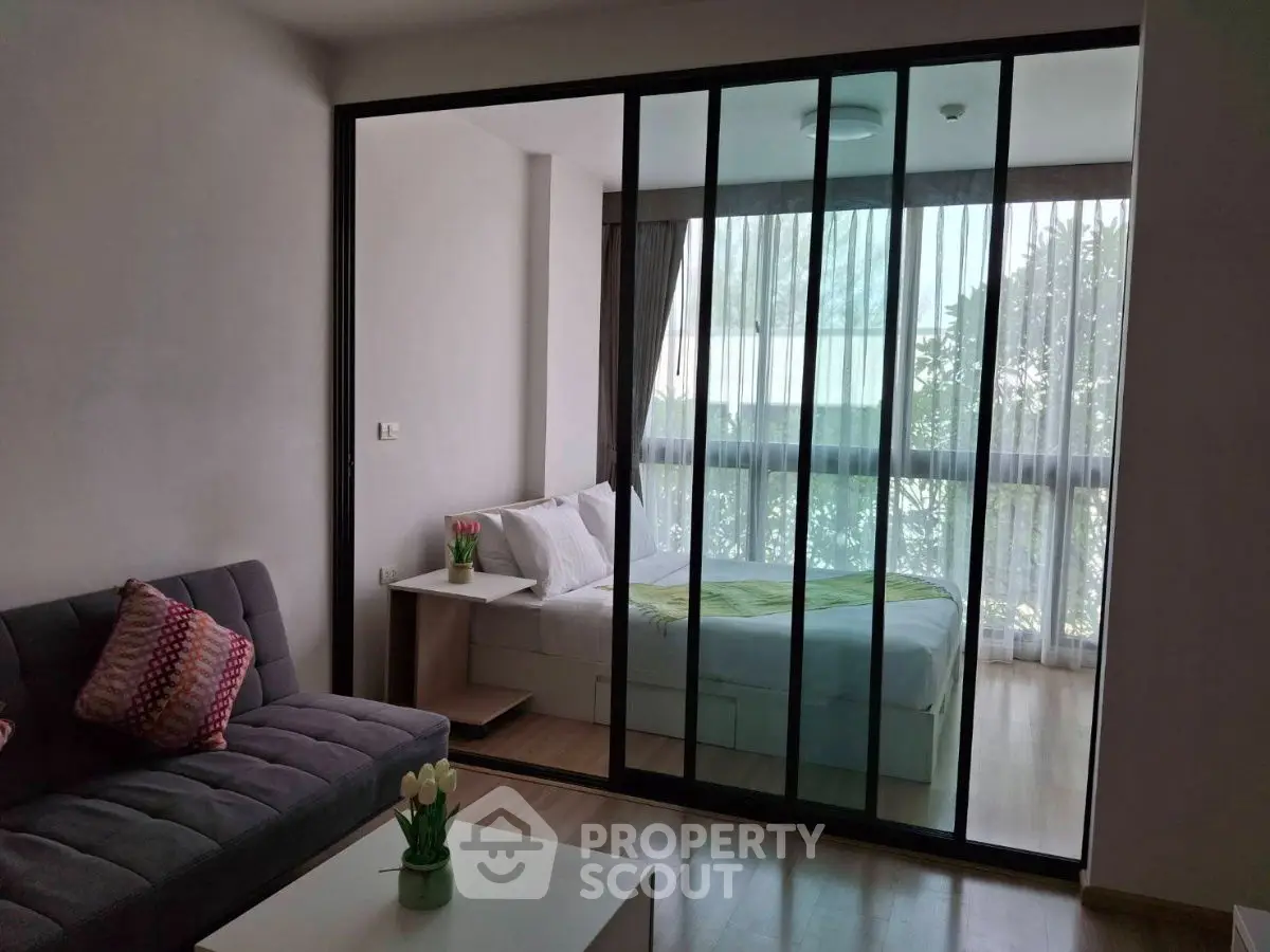 Modern studio apartment with glass partition and cozy decor