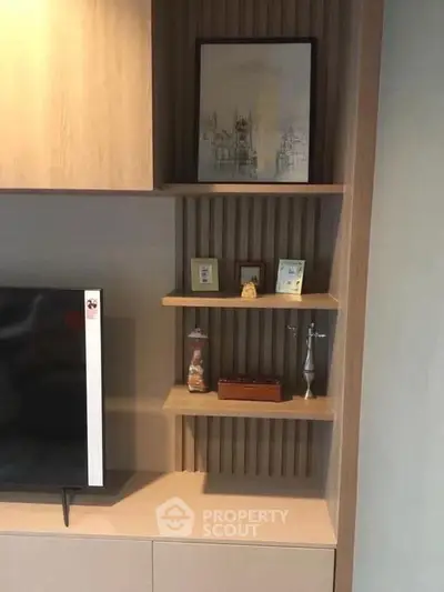 Modern living room with stylish shelving and wall-mounted TV