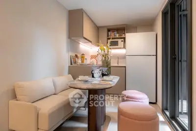 Cozy modern kitchen with open layout, featuring a compact dining area and stylish decor.