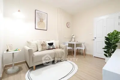 Charming modern living room with cozy sofa, stylish decor, and dining area in a bright, inviting space.