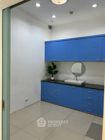 Modern bathroom with blue cabinetry and sleek design