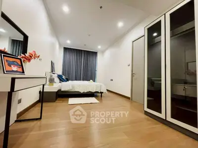 Spacious modern bedroom with elegant decor and ample natural light