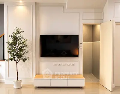 Modern living room with wall-mounted TV and stylish decor