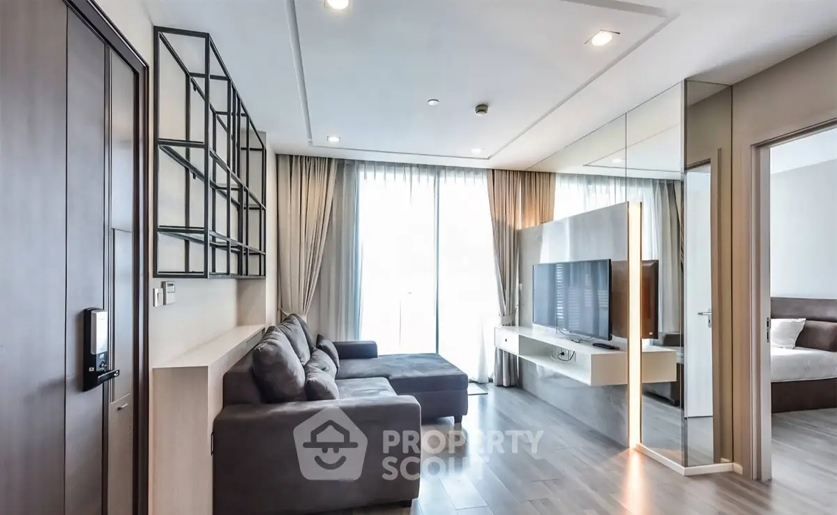 Modern living room with sleek design, large sofa, and floor-to-ceiling windows for natural light.