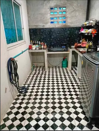 Charming kitchen with checkered floor and modern appliances, perfect for culinary enthusiasts.