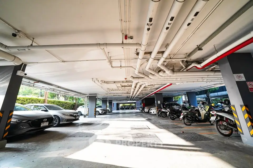 Spacious underground parking area with ample lighting and modern design.