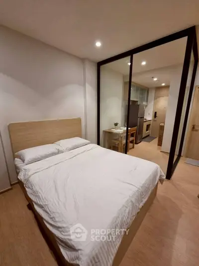 Modern studio apartment with cozy bedroom and open kitchen layout