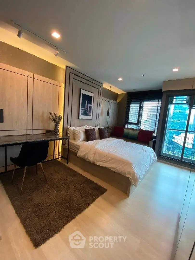 Luxurious modern bedroom with city view, elegant decor, and cozy ambiance.