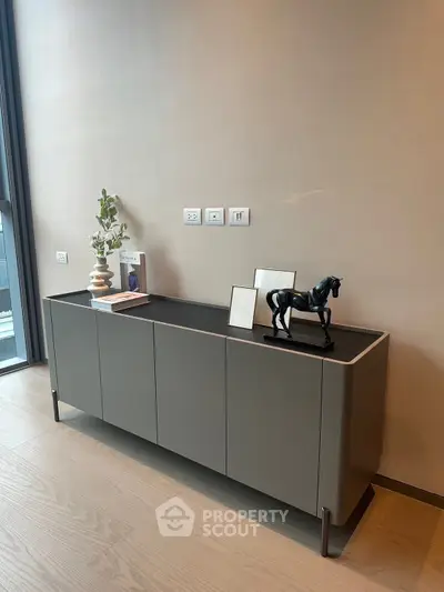 Modern interior with sleek sideboard and decorative accents in stylish living space.
