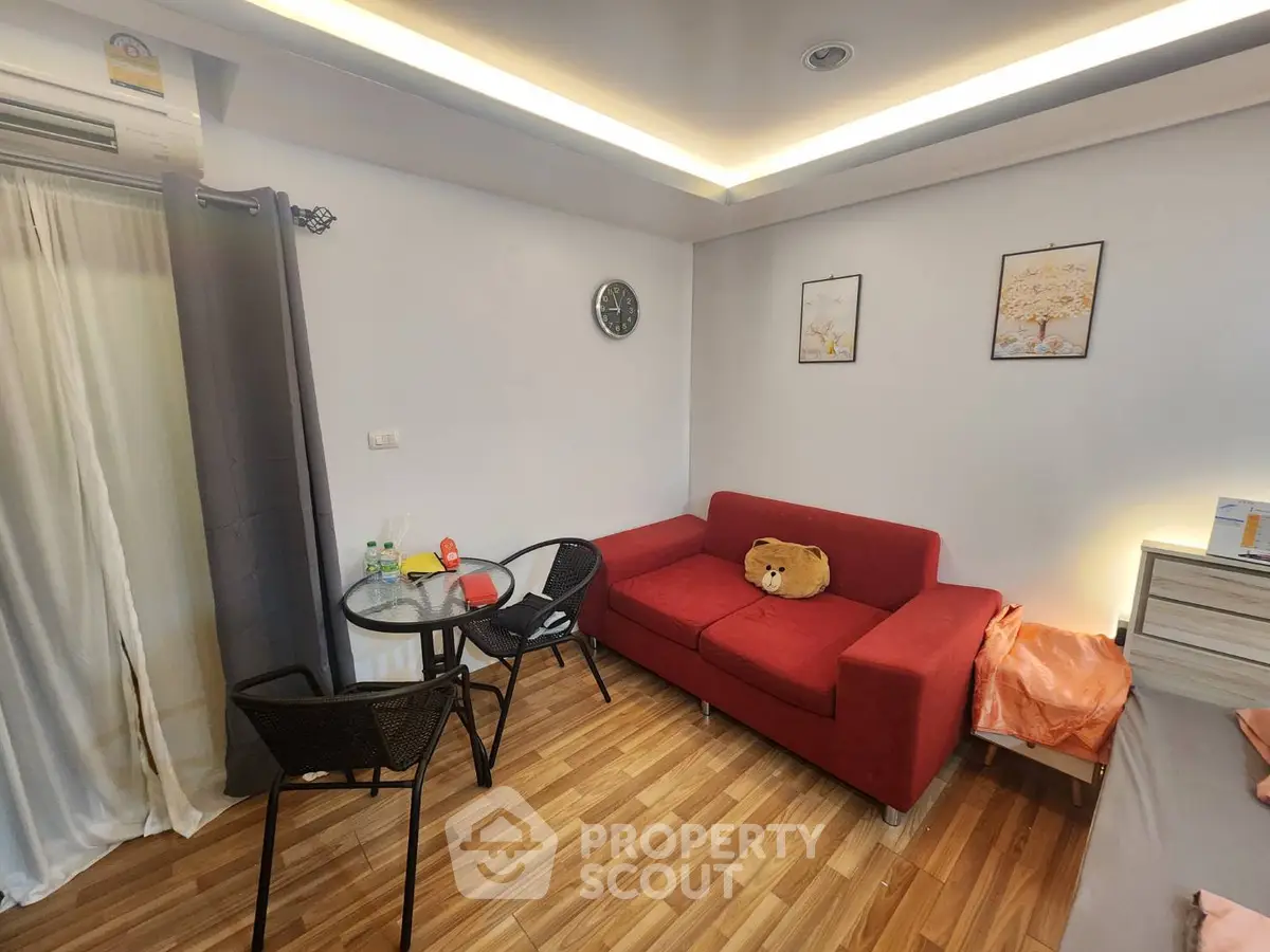 Cozy living room with red sofa and modern decor in a stylish apartment