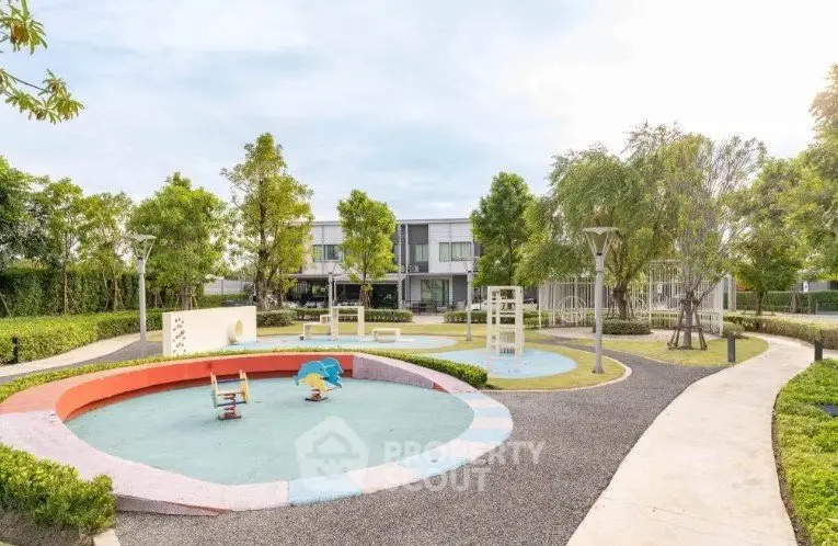 Charming residential playground with modern equipment and lush greenery, perfect for family-friendly living.