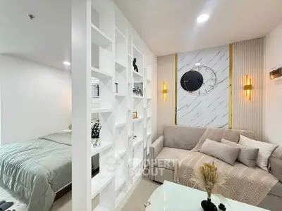 Modern living room with elegant decor and cozy seating area, featuring a stylish partition and wall clock.