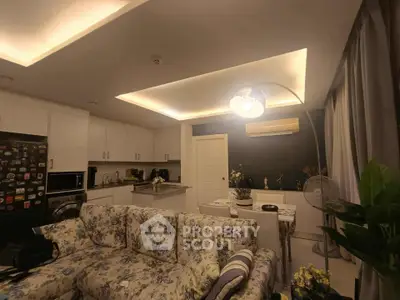 Cozy living room with floral sofa and modern kitchen in open layout