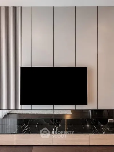 Modern living room with sleek TV setup and elegant marble accents