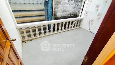 Charming small balcony with tiled floor and decorative railing, perfect for cozy outdoor relaxation.