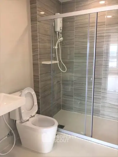 Modern bathroom with glass shower enclosure and sleek tile design