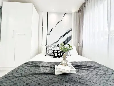 Modern bedroom with stylish decor and natural light