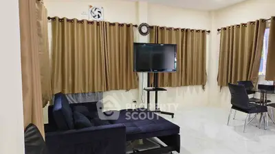 Spacious living room with modern furniture and large windows