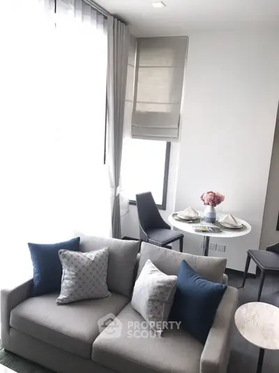 Modern living room with elegant sofa and dining area in bright natural light