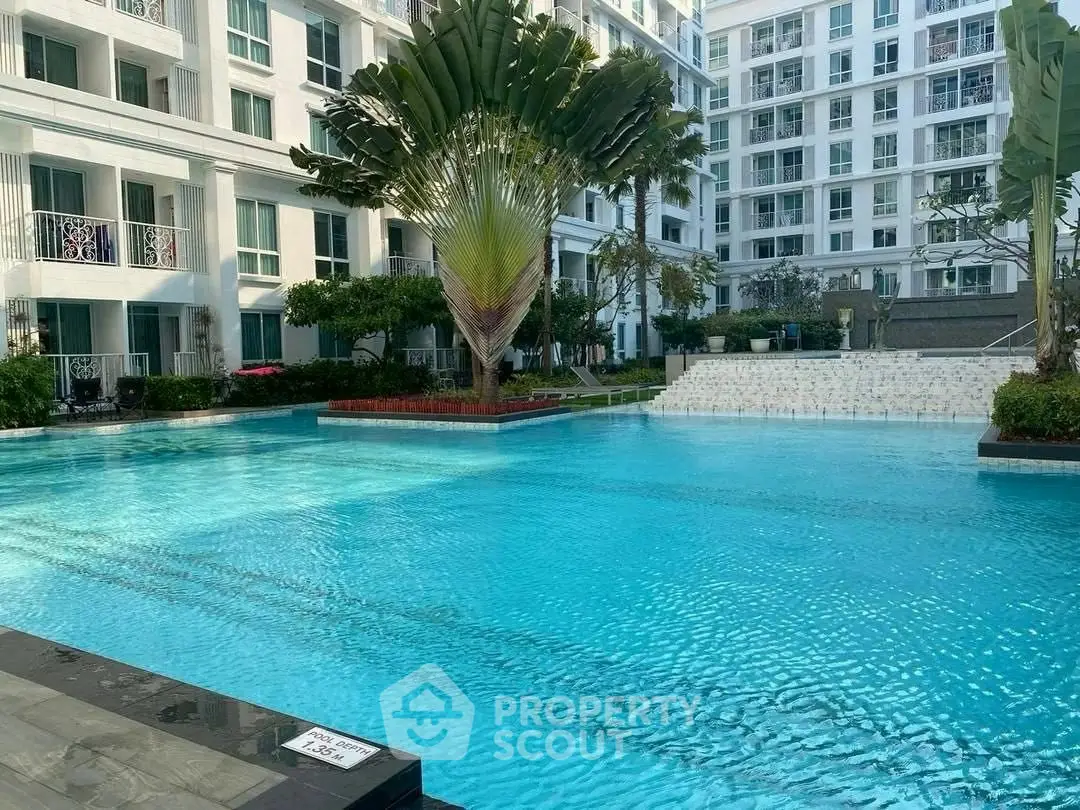 Luxurious residential pool area with modern architecture and lush greenery.