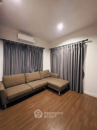 Cozy living room with modern brown sofa and elegant curtains