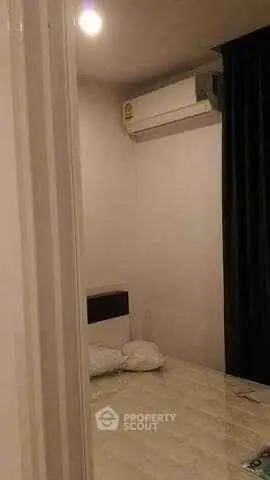 Minimalist bedroom with air conditioning and simple decor