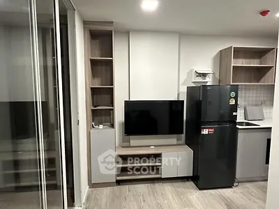 Modern apartment living room with sleek TV setup and contemporary kitchen