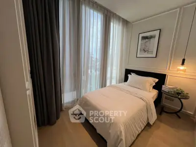 Cozy bedroom with elegant decor and large windows for natural light