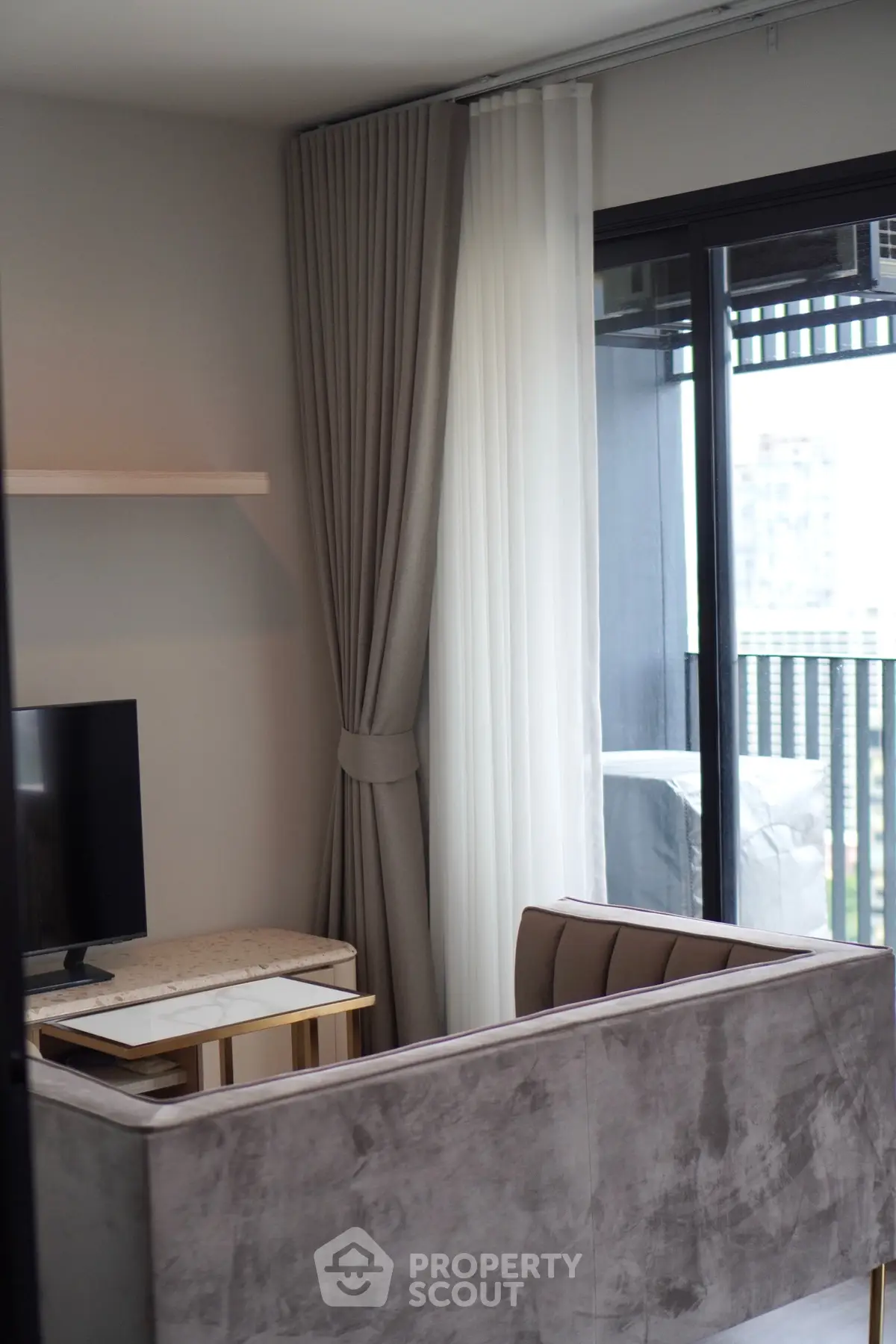Modern living room with elegant decor and city view balcony, perfect for urban living.