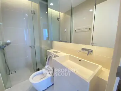 Modern bathroom with sleek fixtures and glass shower enclosure