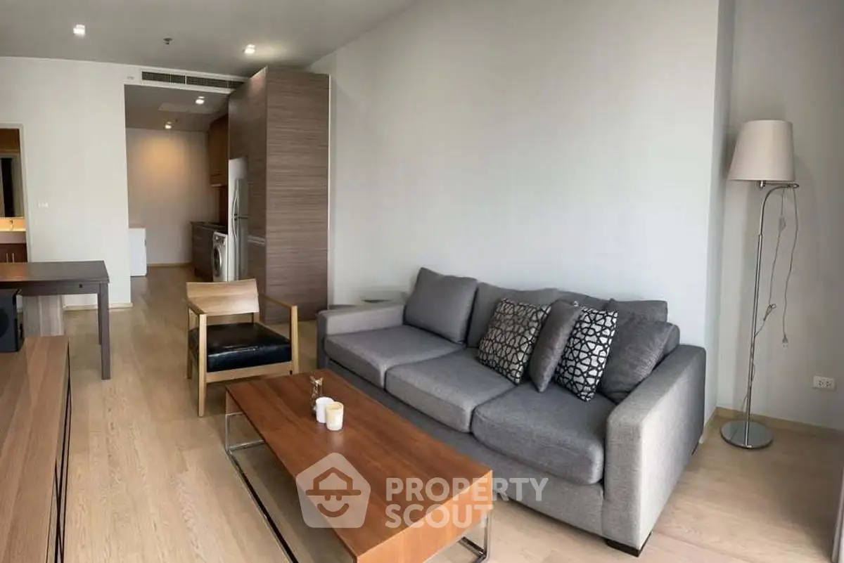 Spacious modern living room with stylish furniture and open layout in a contemporary apartment.