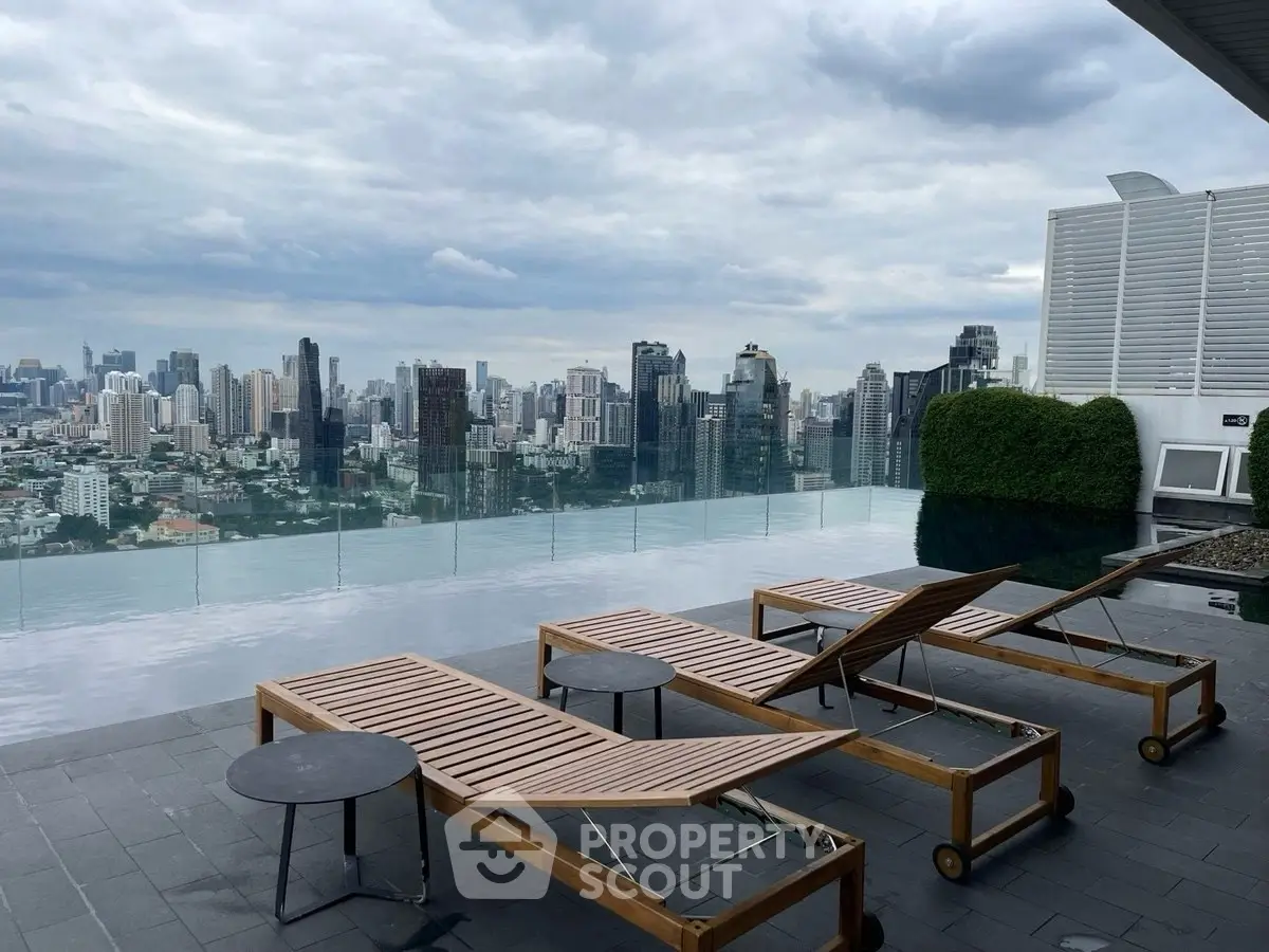 Luxurious rooftop pool with stunning city skyline view and modern lounge chairs.