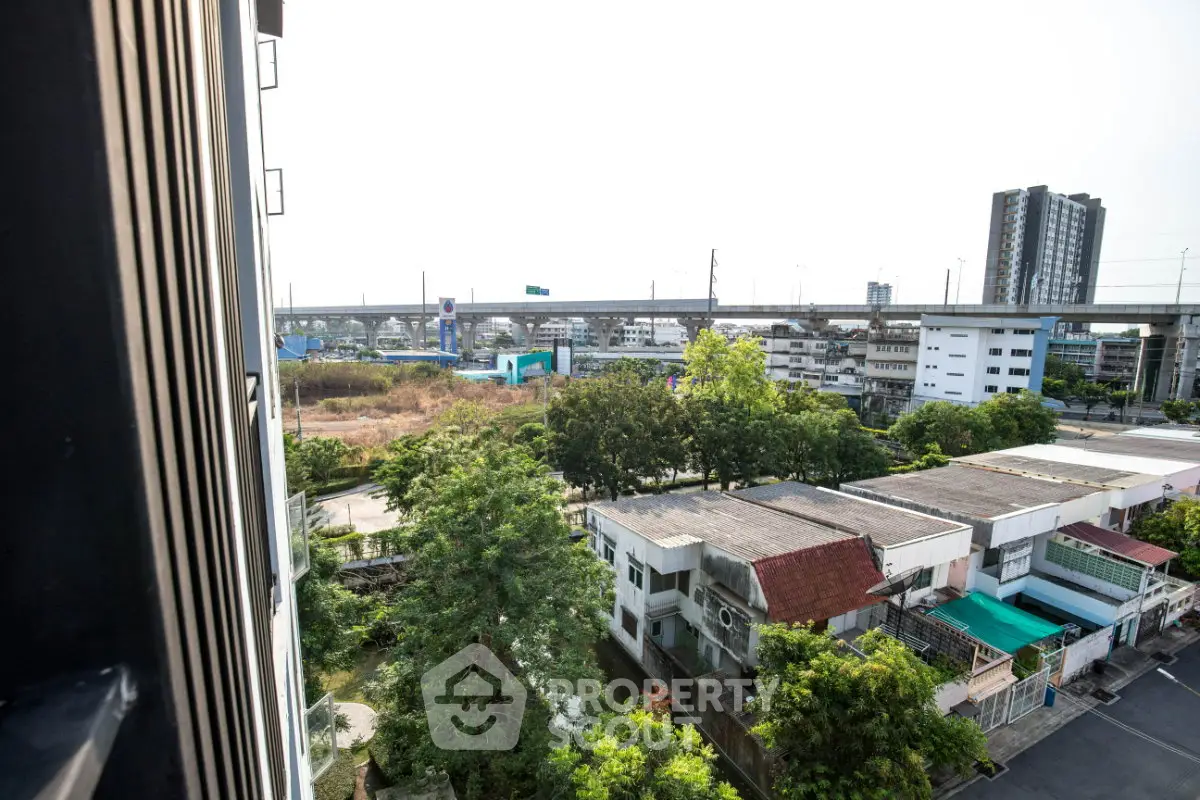 Urban view from high-rise building with highway and residential area