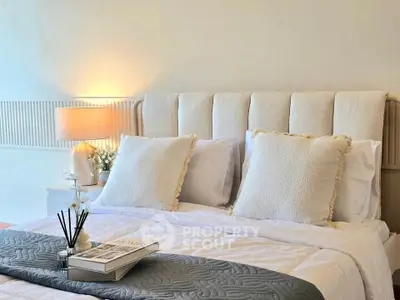 Cozy and elegant bedroom with plush bedding and soft lighting, perfect for relaxation.