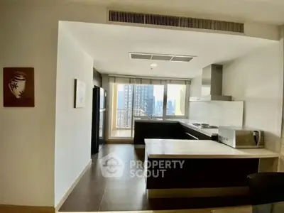Spacious modern kitchen with open layout and city view, featuring sleek appliances and ample counter space.