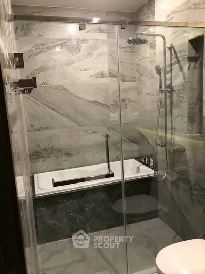 Luxurious marble bathroom with modern shower and bathtub
