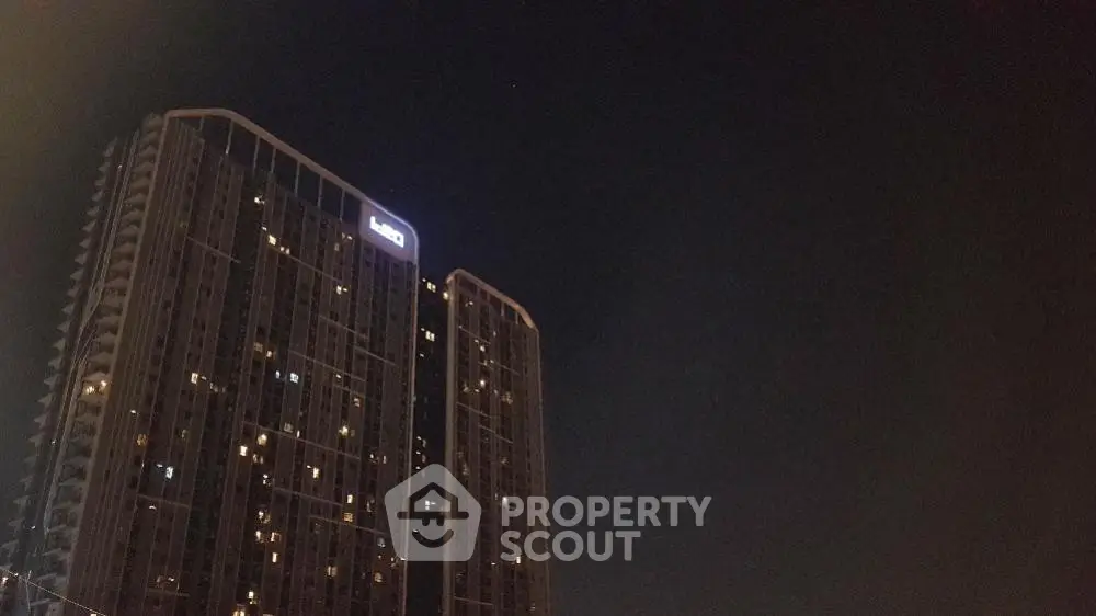 Stunning night view of a modern high-rise building with illuminated windows.